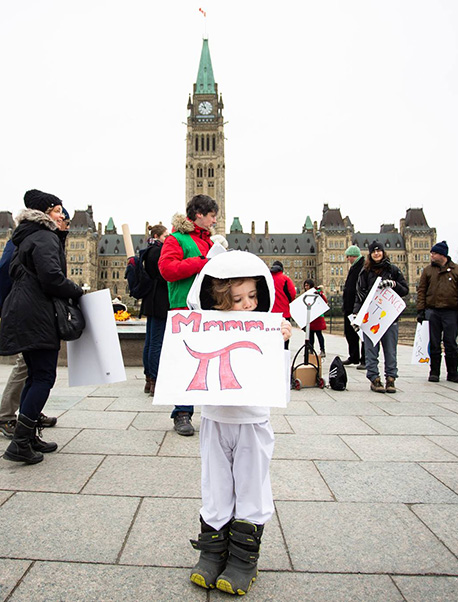 A child holds up a sign that says Mmmm π at an E4D rally at Capitol Hill